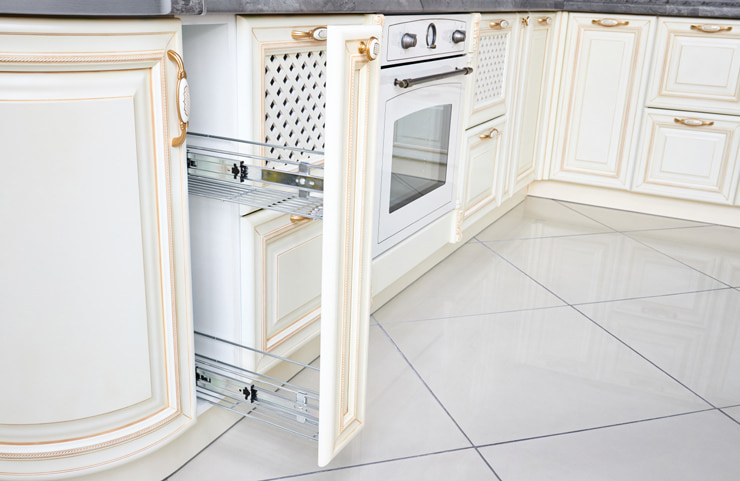 A pull-out pantry drawer in a kitchen cabinetry.