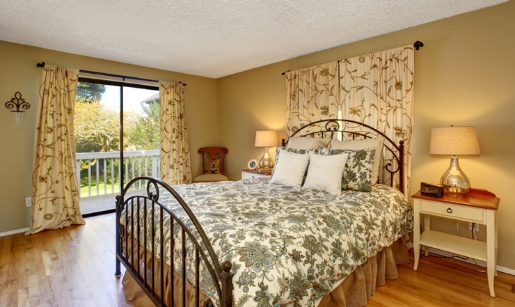A bedroom with floral bed cover