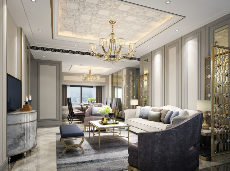 Luxurious beige living room with massive chandelier.