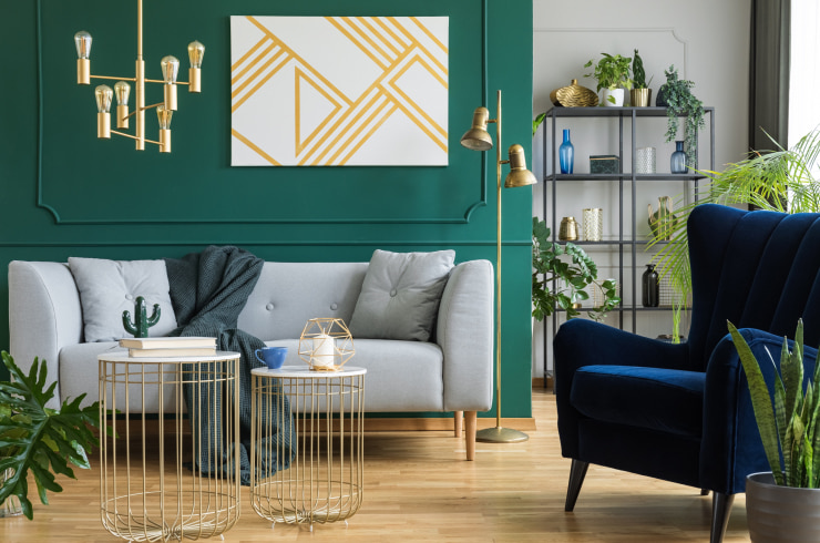 Gray sofa and navy armchair in modern elegant interior.