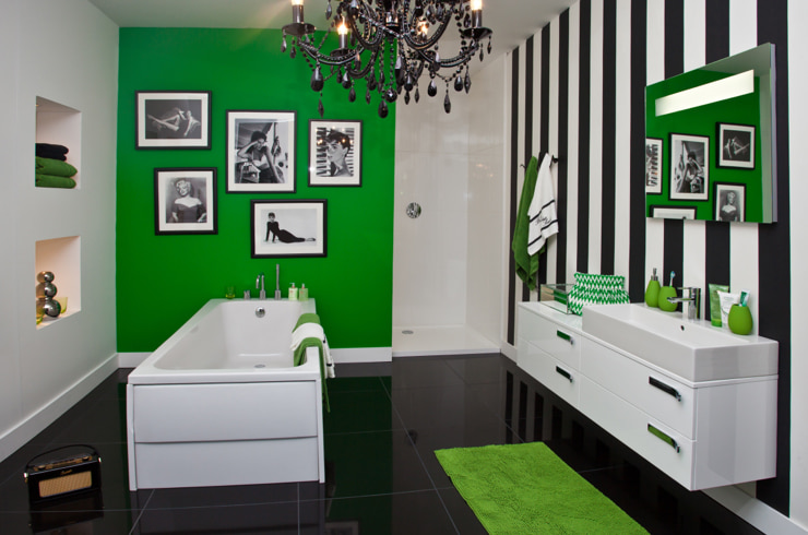 A black and white bathroom with splashes of green color
