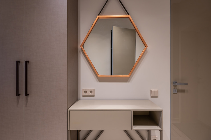 Hexagonal mirror with wooden frame.