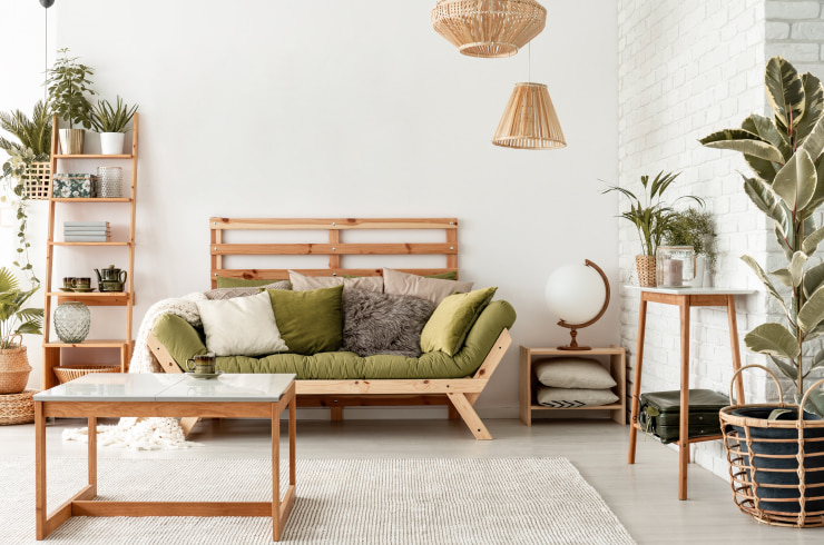 A living room with wooden furniture and lots of potted plants.