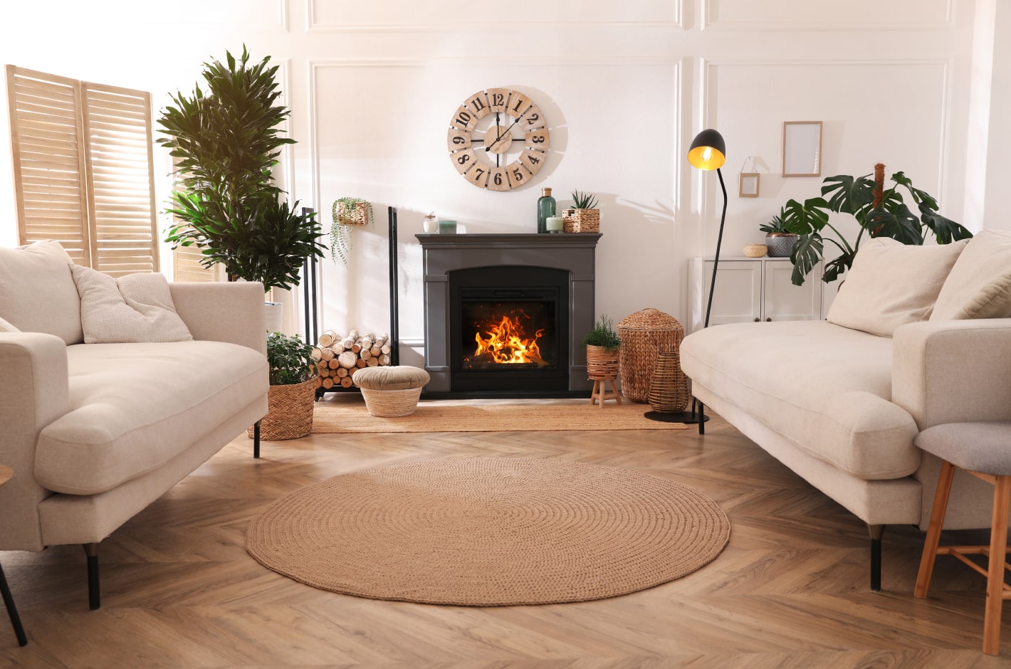 Stylish living room interior with a fireplace, comfortable sofas and beautiful decor elements.