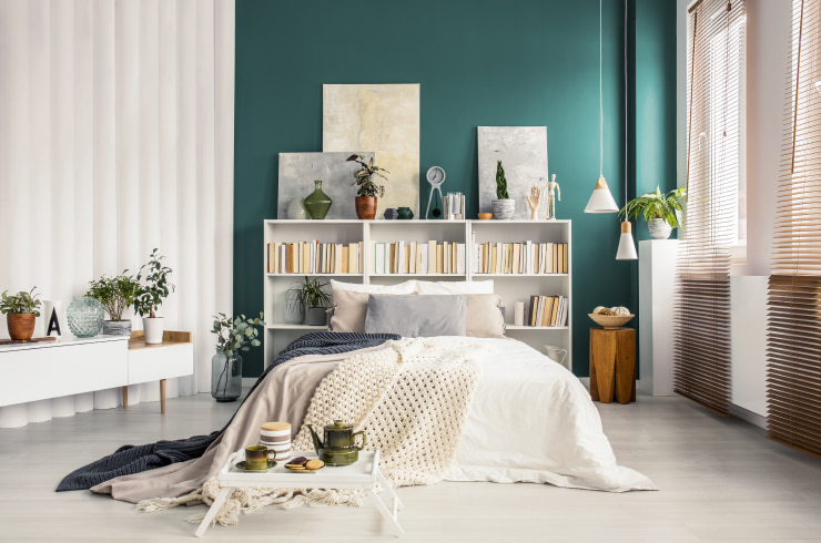Large bed with a bookcase headboard.
