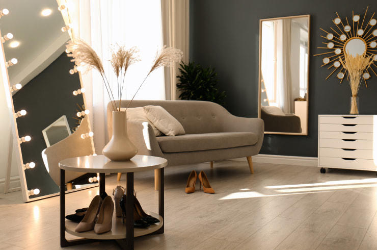 Stylish apartment with large mirrors and pampas grass for decor.