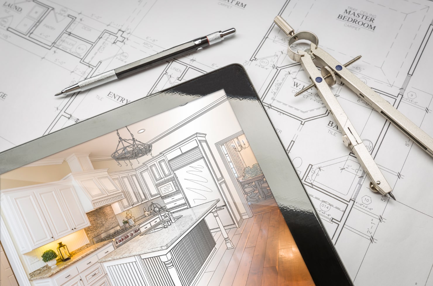 A kitchen renovation project opened on an iPad laying on top of the floor plan.
