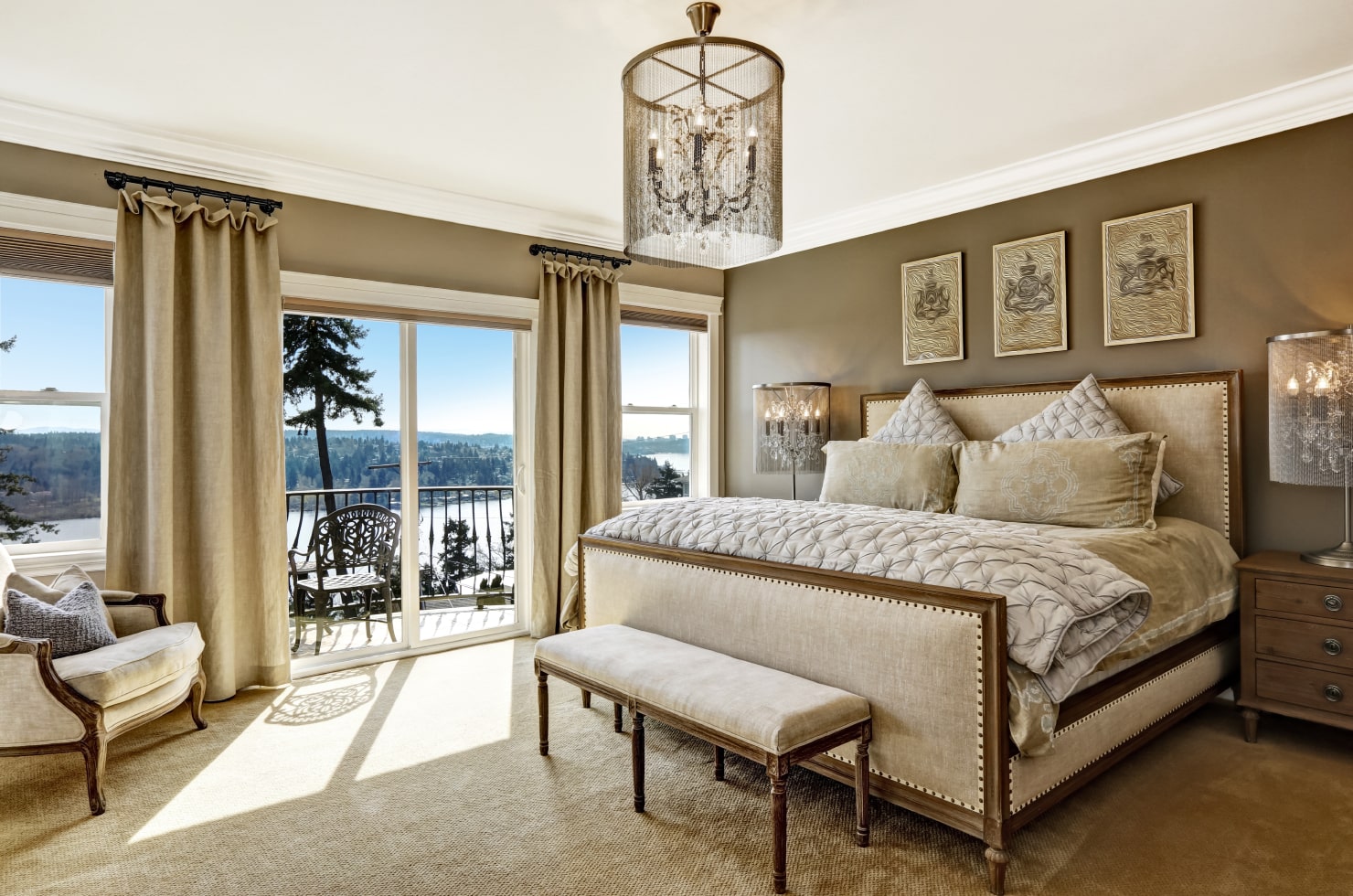 Luxury bedroom interior in beige tones with a king size high bed and panoramic view.