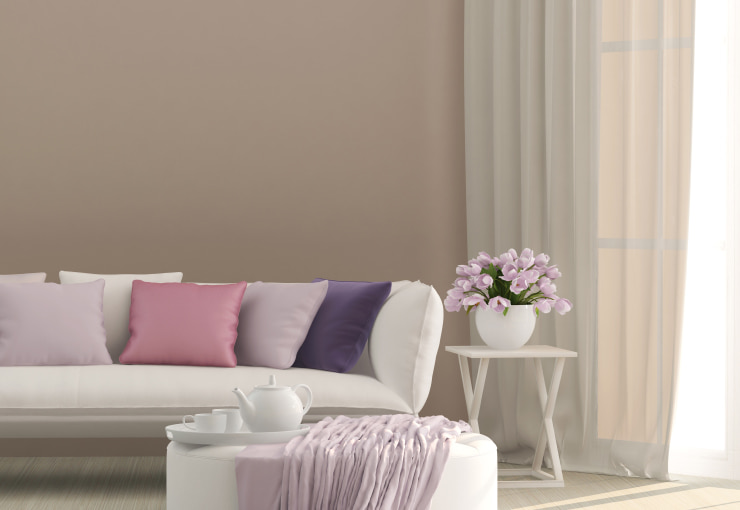 White sofa with multiple colorful decorative pillows.
