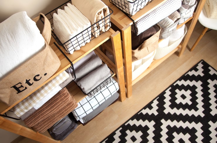 Racks filled with organizers for towels, napkins and linen.