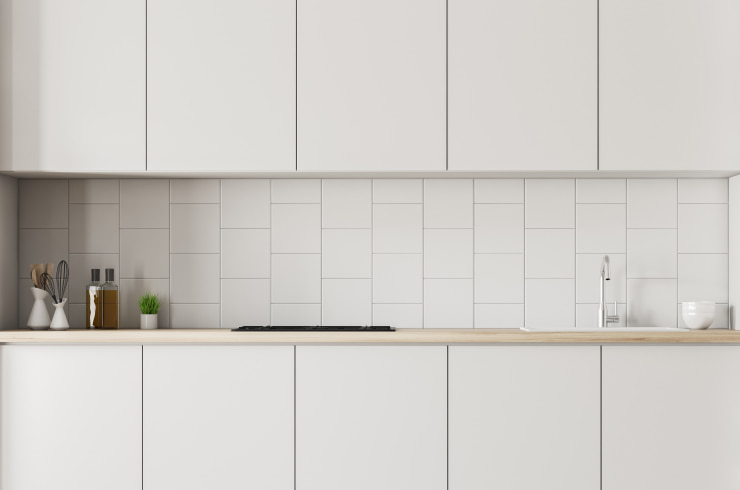 A white kitchen with clean, uncluttered countertops.