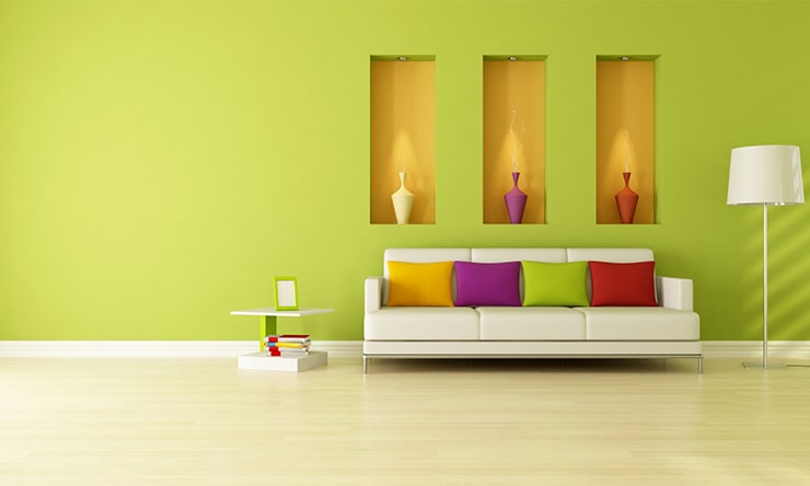 A living room design in green color with a white sofa