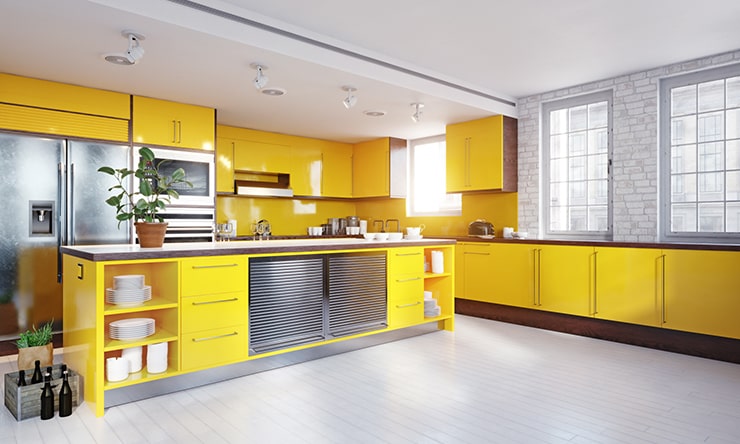 A kitchen with yellow furniture