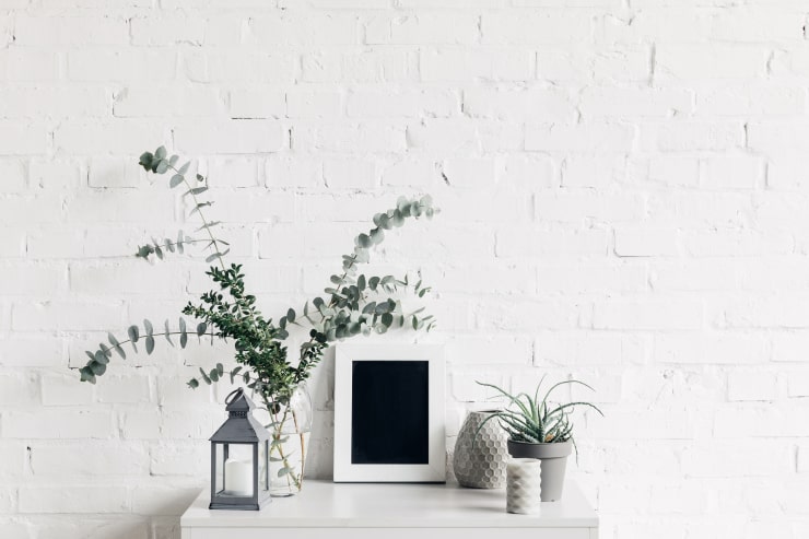 Small white table with decoration and plants