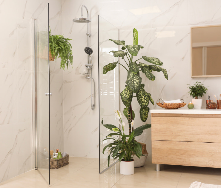 Light marble bathroom with plants.