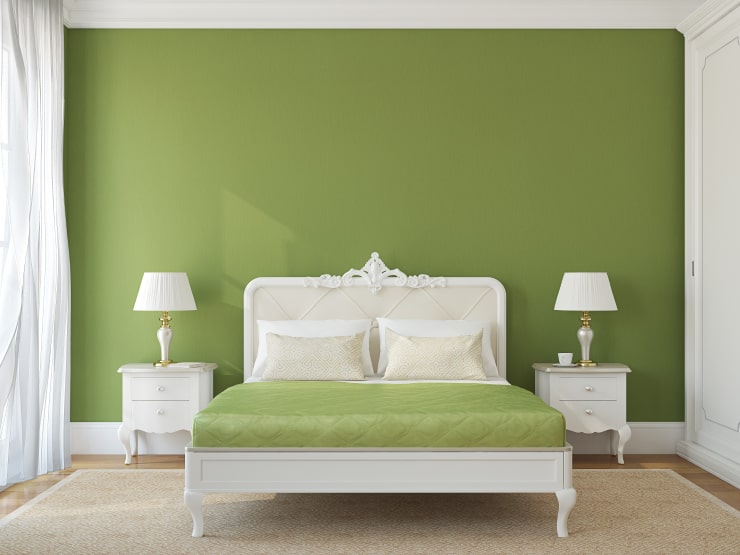 A classic light bedroom with green accents.