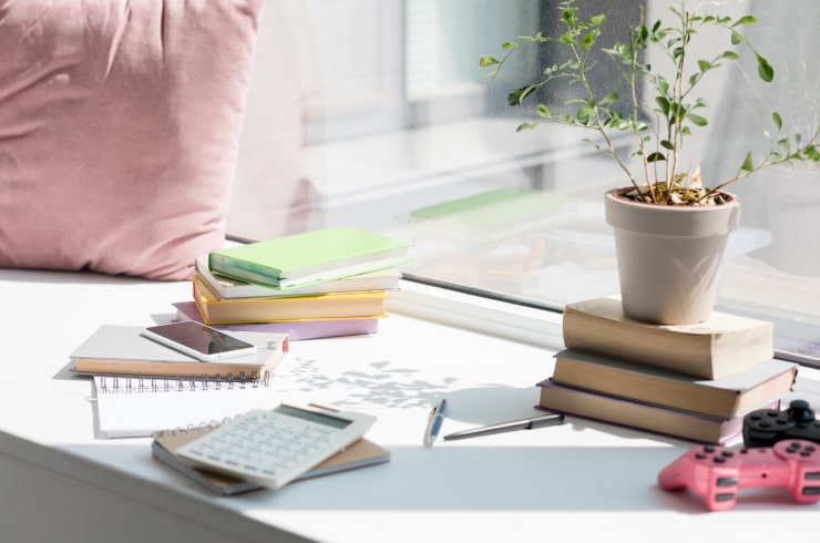 A windowsill with education supplies lying on it.