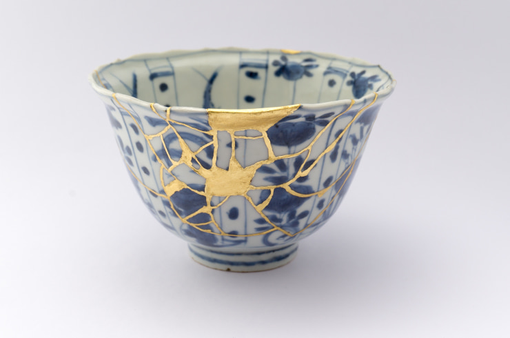 A broken cup mended in kintsugi style.